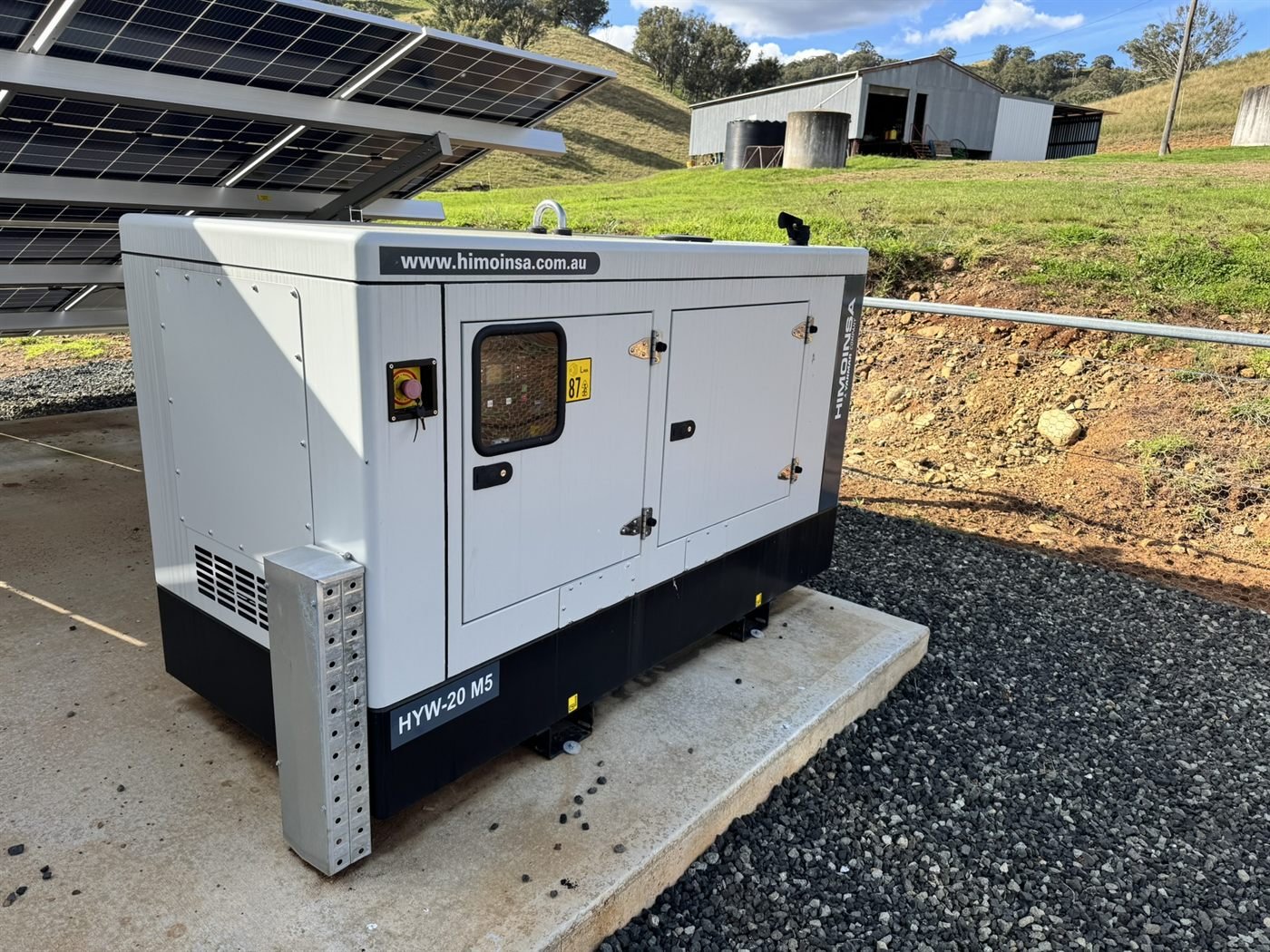Himoinsa backup generator installed beside a ground-mount solar array