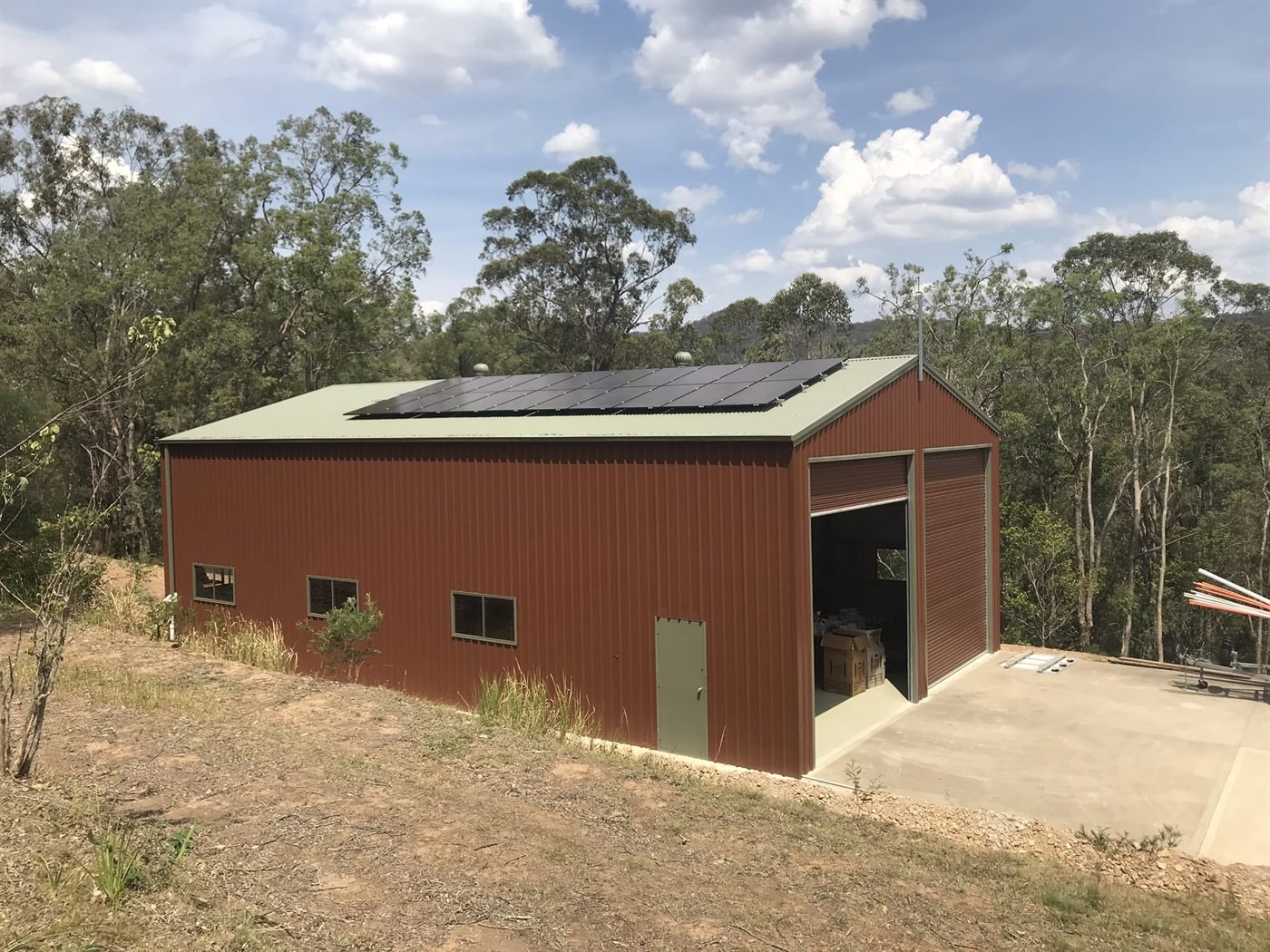 Rural shed with rooftop solar on bushland property